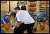 Mrs. Laura Bush watches a basketball demonstration at the Lough View Integrated Primary School's Gym in Belfast, Northern Ireland, June 16, 2008, during her visit to the school with President Bush. 