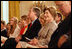 Mrs. Laura Bush smiles as she listens to the acknowledgments of the 2008 Presidential Medal of Freedom recipients during ceremonies Thursday, June 19, 2008, in the East Room of the White House.