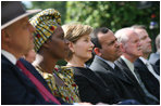 Mrs. Laura Bush listens to participants during a celebration of World Refugee Day Friday, June 20, 2008, in the East Garden of the White House. The event acknowledged the compassion of the American people in welcoming refugees into U.S. society and highlighting their contributions.