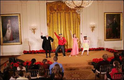 Mrs. Laura Bush, along with invited guests, watches a scene performance Friday, March 7, 2008 in the East Room of the White House, from the theater production of Chasing George Washington: A White House Adventure. The play is part of the Kennedy Center Performances for Young Audiences Series.