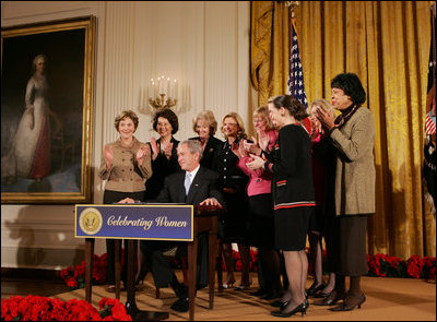 President George W. Bush is applauded by Mrs. Laura Bush, Cabinet members and members of Congress, at the proclamation signing for Women's History Month Monday, March 10, 2008 in the East Room of the White House in honor of Women's History Month and International Women's Day. From left are, U.S. Secretary of Labor Elaine Chao, U.S. Secretary of Transportation Mary Peters; New York Rep. Carolyn Mahoney, Rep. Marsha Blackburn of Tennessee, Rep. Judy Biggert of Illinois, Rep. Mary Fallin of Oklahoma, Rep. Shelley Moore Capito of West Virginia, Rep. Dianne Watson of California and Rep. Jean Schmidt of Ohio.