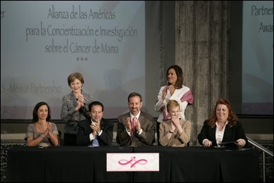 Mrs. Laura Bush applauds following the signing of the U.S.-Mexico Partnership for Breast Cancer Awareness and Research agreement between the Susan G. Komen for the Cure, MD Anderson Cancer Center, U.S. State Department, the Instituto Nacional de Cancerologia and Mexican Association Against Breast Cancer (Fundacion Cim*ab) Friday, March 14, 2008, at the Interactive Economics Museum in Mexico City. From left are Bertha Aguilar, Dr. Alejandro Mohar, U.S Ambassador to Mexico Antonio O. Garza, Jr., Hala Moddelmog, Margarita Zavala (standing), and Dr. Kendra Woods.