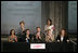 Mrs. Laura Bush applauds following the signing of the U.S.-Mexico Partnership for Breast Cancer Awareness and Research agreement between the Susan G. Komen for the Cure, MD Anderson Cancer Center, U.S. State Department, the Instituto Nacional de Cancerologia and Mexican Association Against Breast Cancer (Fundacion Cim*ab) Friday, March 14, 2008, at the Interactive Economics Museum in Mexico City. From left are Bertha Aguilar, Dr. Alejandro Mohar, U.S Ambassador to Mexico Antonio O. Garza, Jr., Hala Moddelmog, Margarita Zavala (standing), and Dr. Kendra Woods.