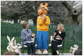 Mrs. Laura Bush, joined by her daughter, Jenna, applauds the PBS character "Arthur," following the reading of "Arthur Meets the President," Monday, March 24, 2008, during festivities at the 2008 White House Easter Egg Roll on the South Lawn of the White House.