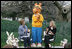 Mrs. Laura Bush, joined by her daughter, Jenna, applauds the PBS character "Arthur," following the reading of "Arthur Meets the President," Monday, March 24, 2008, during festivities at the 2008 White House Easter Egg Roll on the South Lawn of the White House.