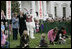 President George W. Bush, joined by Mrs. Laura Bush, blows a whistle Monday, March 24, 2008 on the South Lawn of the White House, to officially start the festivities for the 2008 White House Easter Egg Roll.