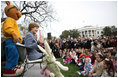 Mrs. Laura Bush, joined by her daughter, Jenna, and the PBS character "Arthur," reads the book "Arthur Meets the President," Monday, March 24, 2008, during festivities at the 2008 White House Easter Egg Roll on the South Lawn of the White House.