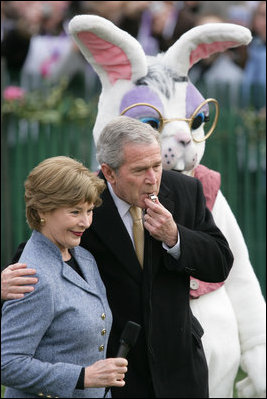 President George W. Bush embraces Mrs. Laura Bush as he blows a whistle Monday, March 24, 2008 on the South Lawn of the White House, to officially start the festivities for the 2008 White House Easter Egg Roll.