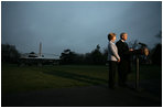 President George W. Bush, accompanied by Mrs. Laura Bush, talks to reporters before their departure to Ukraine Monday, March 31, 2008, on the South Lawn of the White House. President Bush urges Congress to pass the FISA reform bill and to act quickly to approve the Colombian Free Trade Agreement. President and Mrs. Laura Bush depart on a six-day trip to Ukraine, Romania, Croatia, and Russia. President Bush will have a scheduled meeting with Russian President Vladimir Putin.