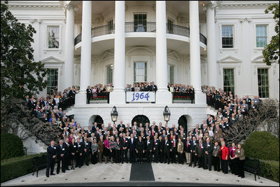 President George W. Bush and Mrs. Laura Bush pose for a photo Saturday evening, March 29, 2008 on the South Portico of the White House, with Mrs. Bush's classmates from the Midland High School graduating class of 1964, during their class reunion gathering at the White House.