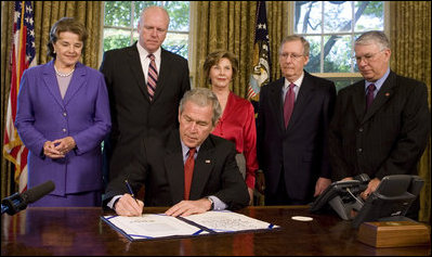 President George W. Bush signs H.R. 4286, Congressional Gold Medal: Daw Aung San Suu Kyi, during a ceremony Tuesday, May 6, 2008, in the Oval Office. The bill awards a congressional gold medal to the Nobel Laureate for her courageous and unwavering commitment to peace, nonviolence, human rights and democracy in Burma. Joining him for the signing are Mrs. Laura Bush, Senator Dianne Feinstein, (D-CA.); Congressman Joe Crowley of New York; Senator Mitch McConnell, (R-KY), and Congressman Don Manzullo of Illinois.