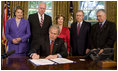 President George W. Bush signs H.R. 4286, Congressional Gold Medal: Daw Aung San Suu Kyi, during a ceremony Tuesday, May 6, 2008, in the Oval Office. The bill awards a congressional gold medal to the Nobel Laureate for her courageous and unwavering commitment to peace, nonviolence, human rights and democracy in Burma. Joining him for the signing are Mrs. Laura Bush, Senator Dianne Feinstein, (D-CA.); Congressman Joe Crowley of New York; Senator Mitch McConnell, (R-KY), and Congressman Don Manzullo of Illinois.