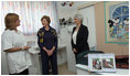 Mrs. Laura Bush and Mrs. Aliza Olmert, spouse of Israeli Prime Minister Ehud Olmert, talk with a staff member during a visit Wednesday, May 14, 2008, to the Tipat Chalav-Gonenim Neighborhood Mother and Child Care Center in Jerusalem.