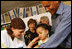 Mrs. Laura Bush looks on during an examination of 1-year-old Orie Holkan during a visit Wednesday, May 14, 2008, to the Tipat Chalav-Gonenim Neighborhood Mother and Child Care Center in Jerusalem. With them are Ms. Sarit Fuast, the nurse, and Talala Holkan, the young child's father.