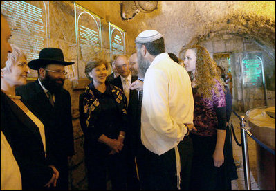 Listening to Mr. Mordechi Eliav as he describes the ongoing construction project that is the Western Wall Tunnels, Mrs. Laura Bush and Mrs. Aliza Olmert, spouse of Israeli Prime Minister Ehud Olmert, participate in a tour of the Jerusalem site.