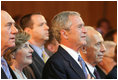 President George W. Bush and Laura Bush are seen with Israeli leaders Prime Minister Ehud Olmert, left, and Israeli President Shimon Peres during the playing of the National Anthem Wednesday, May 14, 2008 in Jerusalem, during a celebration of Israel's 60th anniversary as a nation at the Israeli Presidential Conference 2008 at the Jerusalem International Convention Center.