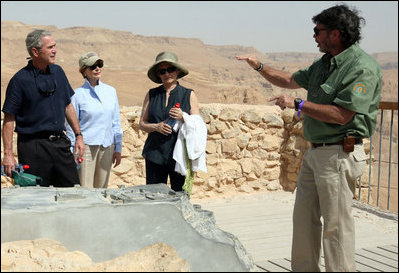 Director Eitan Campbell describes the water system of Masada to President George W. Bush, Mrs. Laura Bush and Mrs. Aliza Olmert, Thursday, May 15, 2008, as they tour the historic fortress built by King Herod of Judea, who ruled from 37 BC to 4 BC and chose the site as a refuge against his enemies and as a winter palace.