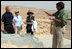 Director Eitan Campbell describes the water system of Masada to President George W. Bush, Mrs. Laura Bush and Mrs. Aliza Olmert, Thursday, May 15, 2008, as they tour the historic fortress built by King Herod of Judea, who ruled from 37 BC to 4 BC and chose the site as a refuge against his enemies and as a winter palace.