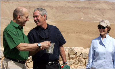 President George W. Bush and Prime Minister Ehud Olmert of Israel, share a moment as they stop during their tour of Masada with Mrs. Laura Bush to learn about the historic fortress's water system.