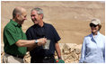 President George W. Bush and Prime Minister Ehud Olmert of Israel, share a moment as they stop during their tour of Masada with Mrs. Laura Bush to learn about the historic fortress's water system.