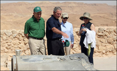 Prime Minister Ehud Olmert, Mrs. Laura Bush and Mrs. Aliza Olmert listen as President George W. Bush talks about the water system at Masada, the historic fortress built by King Herod of Judea. The couple's toured the National Park Thursday, May 15, 2008, during the visit to Israel by President and Mrs. Bush to help celebrate the 60th anniversary of the country's independence.