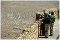 President George W. Bush and Mrs. Laura Bush and Prime Minister Ehud Olmert of Israel and Mrs. Aliza Olmert stand on the upper level of Masada, a palatial fortress built by King Herod, and listen to Eitan Campbell, Director of Masada National Park during their visit to the historic site Thursday, May 15, 2008. On the fringe of the Judean Desert near the shore of the Dead Sea, the camps, fortifications and assault ramp at its base constitute the most complete surviving ancient Roman siege system in the world.