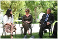 Mrs. Laura Bush and President George W. Bush listen to a young participant during a roundtable discussion Friday, May 16, 2008, in the garden of the Bible Lands Museum Jerusalem.