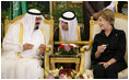 With the help of an interpreter, Mrs. Laura Bush shares a greeting over coffee with King Abdullah bin Abdulaziz during the arrival ceremonies Friday, May 16, 2008, for she and President George W. Bush at the Riyadh-King Khaled International Airport in Riyadh.