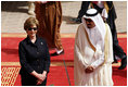 Mrs. Laura Bush and President Bush are greeted by Saudi delegation members during arrival ceremonies Friday, May 16, 2008, at Riyadh-King Khaled International Airport in Riyadh.