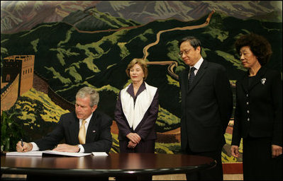 President George W. Bush signs his condolences for the victims of China's May 12, earthquake as he and Mrs. Laura Bush visit the Embassy of the People's Republic of China Tuesday, May 20, 2008, in Washington, D.C. With them are China's Ambassador to the United States Wenzhong Zhou and his spouse, Shumin Xie.