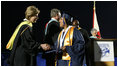 Mrs. Laura Bush congratulates a graduate during commencement exercises Thursday, May 29, 2008, at Enterprise High School in Enterprise, Alabama. Mrs. Bush was on hand to deliver the commencement address, and she told the class -- that lost four of its members in deadly tornadoes last year -- and told the Class of 2008, "As you graduate tonight, take with you memories of your teachers' and classmates' support after the storm, the blue and white worn by students at rival schools, and the donations that came pouring in from around the country."