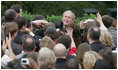 President George W. Bush reaches out to staff members of the Executive Office of the President Thursday, Nov. 6, 2008, after speaking to them on the upcoming presidential transition. The President was joined by his Cabinet, Vice President and Mrs. Cheney and Mrs. Laura Bush as he told his staff, "As January 20th draws near, some of you may be anxious about finding a new job, or a new place to live... But between now and then, we must keep our attention on the task at hand -- because the American people expect no less."