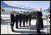 President George W. Bush, joined by Mrs. Laura Bush, stands outside Air Force One as he addresses his remarks in honor of Veterans Day, Tuesday, Nov. 11, 2008 upon the President's arrival at John F. Kennedy International Airport in New York. President Bush introduced military personnel representing the five branches of the armed services, who traveled with him aboard AF-1, honoring their service, from left are, U.S. Navy Chief Petty Officer Shenequa Cox of Dallas, Texas; U.S. Coast Guard Petty Officer First Class Christopher O. Hutto of Homer, Alaska; U.S. Army National Guard SSgt Michael Noyce-Merino of Melrose, Montana; U.S. Air Force Senior Airman Alicia Goetschel of Warrensburg, Mo., and U.S. Marine Corps Sgt. John Badon of Lufkin, Texas.