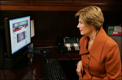 Mrs. Laura Bush, as part of her briefing Friday, Nov. 14, 2008 on the acid attack against young women on their way to school Wednesday in Kandahar, Afghanistan, reviews press footage about the incident in the East Wing at the White House.