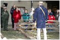 Mrs. Laura Bush watches with children as a reenactor demonstrates rail splitting during her visit to the Abraham Lincoln Birthplace National Historical Site Tuesday, Nov. 18, 2008, in Hodgenville, KY.