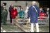 Mrs. Laura Bush watches with children as a reenactor demonstrates rail splitting during her visit to the Abraham Lincoln Birthplace National Historical Site Tuesday, Nov. 18, 2008, in Hodgenville, KY.