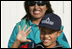 A very proud 8-year-old William Sebastian Hernandez Jeri holds up his hand to show how clean it is after demonstrating hand-washing techniques Friday, Nov. 21, 2008, for Mrs. Laura Bush at the San Clemente Health Center in San Clemente, Peru. Looking on is Ms. Nancy Quispitupa, Program Manager and Community Trainer.