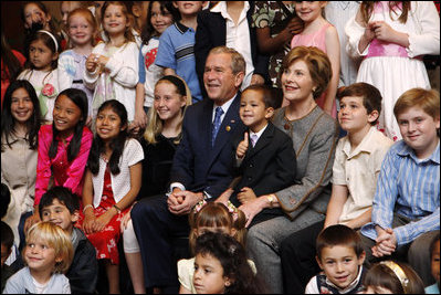 President George W. Bush and Mrs. Laura Bush sit for a photo with the children of U.S. Embassy staff Sunday, Nov. 23, 2008, in Lima. Peru.