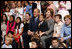 President George W. Bush and Mrs. Laura Bush sit for a photo with the children of U.S. Embassy staff Sunday, Nov. 23, 2008, in Lima. Peru.