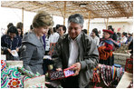 Mrs. Laura Bush listens as an artist describes his work Saturday, Nov. 22, 2008, at the conclusion of the APEC spouses' tour of the Pachacamac Archaeological Site in Lurin, Peru.