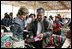 Mrs. Laura Bush listens as an artist describes his work Saturday, Nov. 22, 2008, at the conclusion of the APEC spouses' tour of the Pachacamac Archaeological Site in Lurin, Peru.