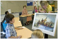 Mrs. Laura Bush watches during a visit to the fourth-grade classroom of Susan Weekes at the Riverside Elementary School in Bismarck, N.D., Thursday, Oct. 2, 2008, as Ms. Weekes shows students a painting by Emanuel Leutze of General George Washington crossing the Delaware River. The First Lady was visiting the school to highlight the National Endowment for the Humanities ' Picturing America' program which provides iconic artwork and photography for students to study.