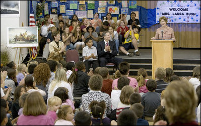 Mrs. Laura Bush addresses the Riverside Elementary School assembly in Bismarck, N.D., Thursday, Oct. 2, 2008, about the National Endowment for the Humanities' Picturing America' program. The program uses iconic artwork - such as the Washington Crossing the Delaware painting displayed nearby - and photography to teach children about architecture, art, and history as they discuss the images.