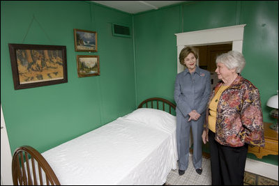 Mrs. Jean Coday, Director and President of the Laura Ingalls Wilder Historic Home and Museum, shows Mrs. Laura Bush the famous author's simple bedroom in Mansfield, Mo., Oct. 3, 2008. The home is where the "Little House" book series was written. Mrs. Bush, who is encouraging Americans to read our country's literary classics, noted that Laura Ingalls Wilder is an American author whose books have been loved by children and adults for over 70 years. The First Lady's mother read the books to her as a child before she could read. This week the home was designated a Save America's Treasures project.