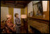 Mrs. Laura Bush looks at a portrait of Laura Ingalls Wilder and her husband on the Wilder home mantle Oct. 3., 2008, in Mansfield, Mo. Laura Ingalls married Almanzo Wilder in the summer of 1885 and moved to the Mansfield home where the "Little House" book series was written in 1894. Mrs. Jean Cody, Director and President of the Laura Ingalls Wilder Historic Home and Museum, explains that the mantle was something that the author really wanted to have. Her husband objected but obviously finally gave in. Wilder, who has been read by children and adults for over 70 years, is one of Mrs. Bush's favorite authors. The visit was used to help encourage American's to read their classic literature which defines us as a nation, reflects our history and bring us together by expressing our shared ideals.