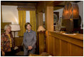 Mrs. Laura Bush admires a steel lamp at the Mansfield, Mo., home of Laura Ingalls Wilder. Mrs. Jean Coday, Director and President of the Laura Ingalls Wilder Historic Home and Museum, explains that the lamp originally belonged to the well-known author's sister. This week the Laura Ingalls Wilder Historic Home and Museum was designated a Save America's Treasures project.