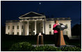 Mrs. Laura Bush prepares to push the button, Oct. 7, 2008, to light up the White House in a pink glow as part of Breast Cancer Awareness. Preventing and curing breast cancer is a cause that Mrs. Bush has worked toward around the world.