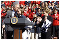 President George W. Bush kisses Army Lieutenant Melissa Stockwell, Paralympian and Iraq war veteran, after she presents President Bush and Mrs. Laura Bush with the American Flag that flew over the Olympic Village in Beijing following his remarks to members of the 2008 United States Summer Olympic and Paralympic Teams Tuesday, Oct. 7, 2008, on the South Lawn of the White House.