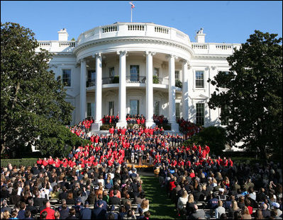 President George W. Bush joined by Mrs. Laura Bush receives applause during his remarks to the members of the 2008 United States Summer Olympic and Paralympic Teams Tuesday, Oct. 7, 2008, on the South Lawn of the White House. President Bush said, "You amazed the world with your talent and grace and sportsmanship. You inspired children to chase their dreams. You will be champions forever."