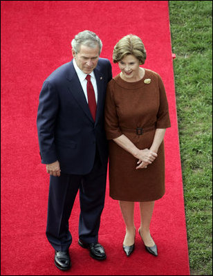 President George W. Bush and Mrs. Laura Bush stand together as they wait for the arrival of Prime Minister Silvio Berlusconi of Italy Monday, Oct. 13, 2008, during a South Lawn ceremony for the Prime Minister at the White House.